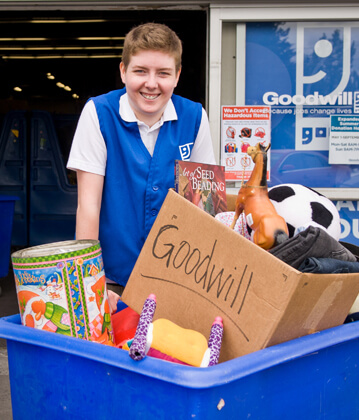 Goodwill worker smiling while collecting donations