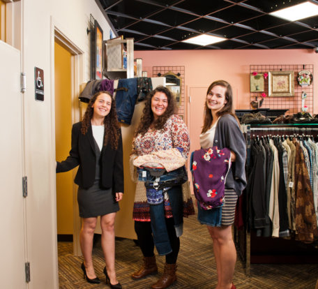 Three women shopping at a Goodwill boutique