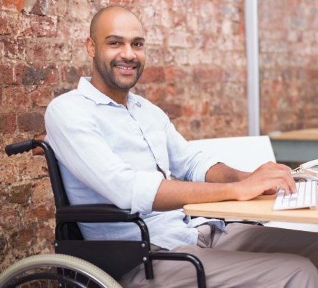 man in wheelchair typing