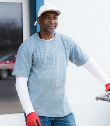 Goodwill Volunteer working with red globes