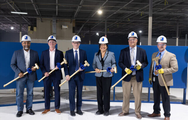 OCPS, Orange County Commissioners, and Goodwill president and CEO Ed Durkee hold golden sledgehammers