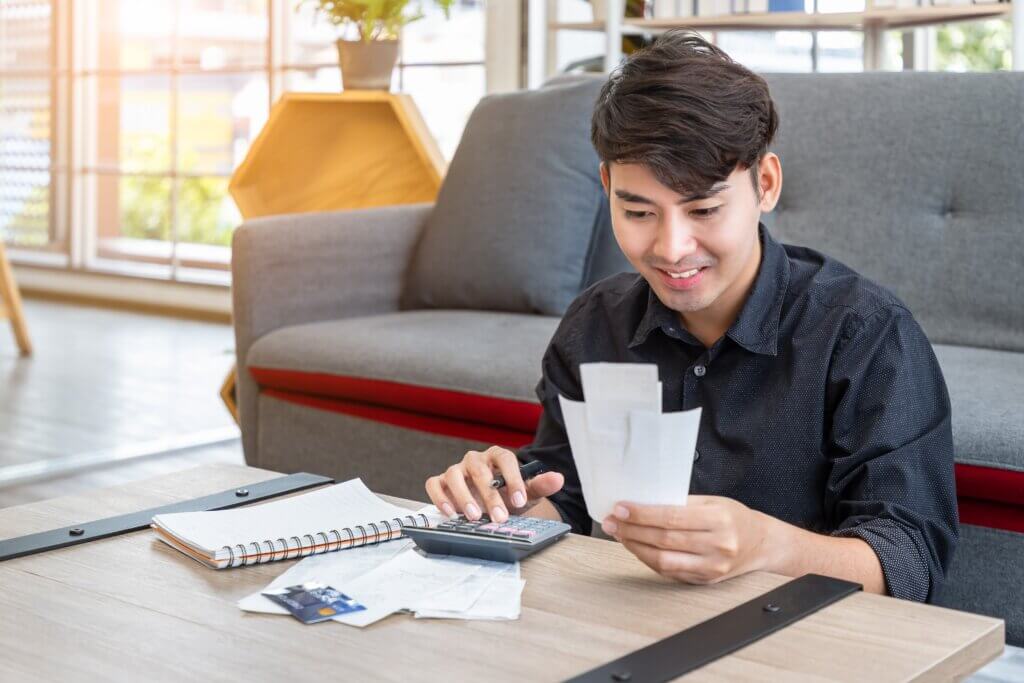 Man looks at receipts and smiles