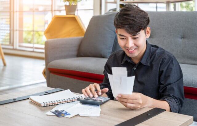 Man looks at receipts and smiles