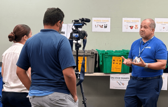 Two men and a woman in front of a camera talking about Goodwill Scholars.
